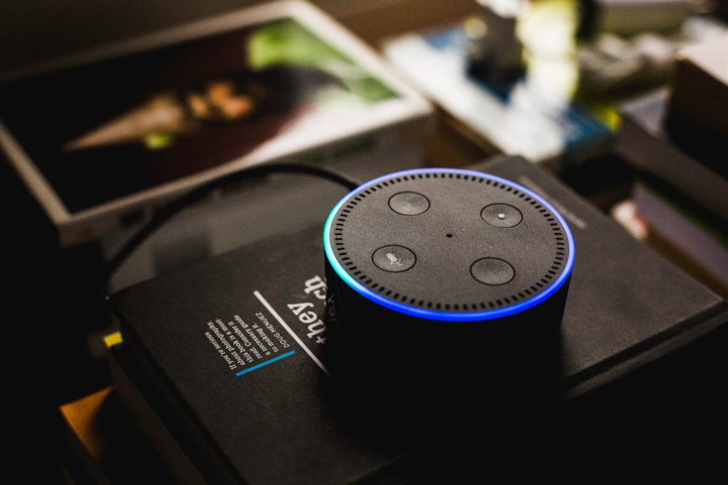 An Alexa sitting on her packaging and lit up